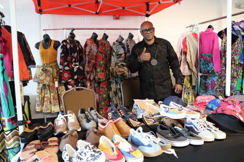 A vendor at his clothing and shoe table at a BIYC First Sundays market